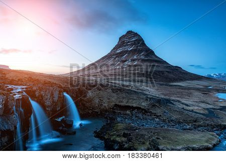 Spring Sunrise Over The Famous Kirkjufellsfoss Waterfall With Kirkjufell Mountain In The Background