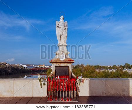Archangel Raphael on stone Roman bridge over the Guadalquivir River. Cordoba. Andalusia.