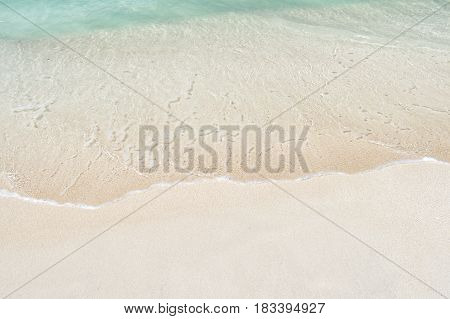 Beautiful marine view on ?aribbean sea coast line with clean wavy surf ocean water on sandy beach in st. john Antigua at sunny day as natural background