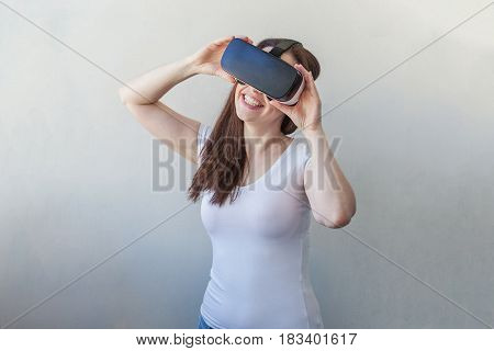 Smile happy young woman using the virtual reality headset on white background