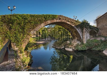 Medieval bridge over Miera river in Lierganes Cantabria Spain.
