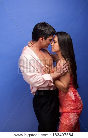 The sexy couple is in a darling embrace.