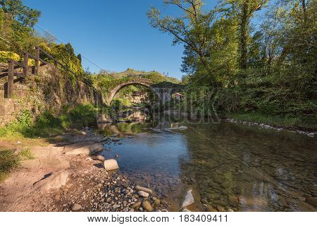 Medieval bridge over Miera river in Lierganes Cantabria Spain.