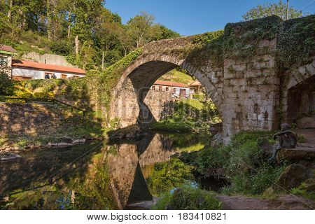 Medieval bridge over Miera river in Lierganes Cantabria Spain.