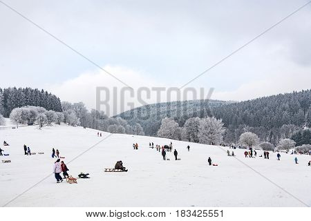 Hildren Are Skating At A Toboggan Run In Winter On Snow.