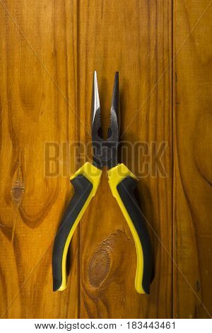 Close up of a multitool pliers on wooden background