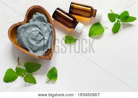 Cosmetic face mask and body made of blue clay mint leaves and essential oils.