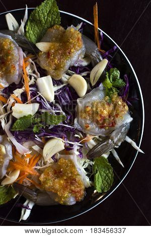 raw prawns with Thai spicy sauce on top.