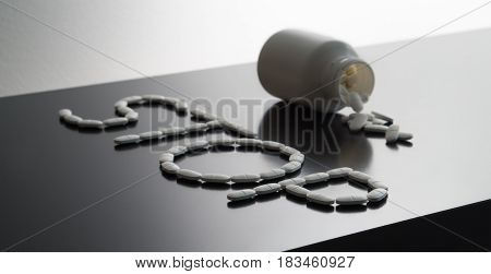 Stop medicine violation or against unethical medical business. Rehab or no drugs theme with dramatic lighting. Zero tolerance or anti doping concept with pills spilled on table from bottle.