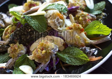 Thai Spicy Sauce on top of raw crabs.
