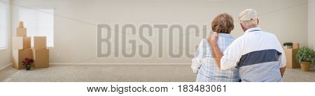Loving Senior Couple Looking Inside Room with Boxes Banner.