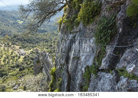 Climbing metal cables hitched on rock for via ferratas on background of beautiful landscape