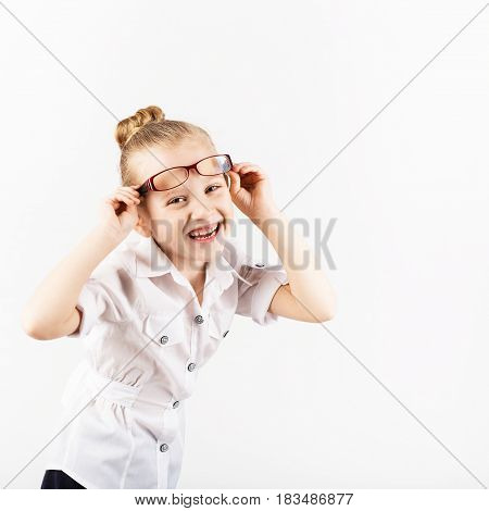 Funny Little Girl Wearing Eyeglasses Imitates A Strict Teacher Against White Background
