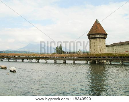 Wooden bridge Kapelbrucke and the Wasserturm tower, Lucerne, Switzerland..
