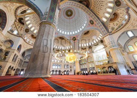 ANKARA, TURKEY - March 13, 2017: Kocatepe Mosque interior view during prayer.  The Mosque is the largest in Ankara and was built between 1967 and 1987.