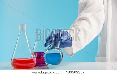 Experiments in a chemistry lab. conducting an experiment in the laboratory with humen hands
