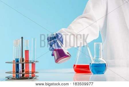 Experiments in a chemistry lab. conducting an experiment in the laboratory with humen hands