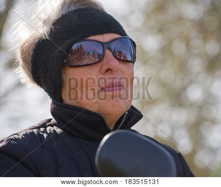 Portrait of a woman in the age of riding a scooter. Age 70 years. Ukraine. Europe.