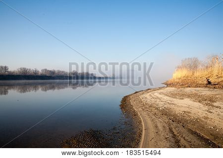 Morning on the river early morning reeds mist fog and water surface on the river