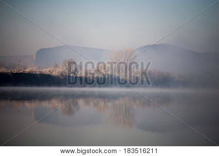 Morning on the river early morning reeds mist fog and water surface on the river