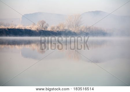 Morning on the river early morning reeds mist fog and water surface on the river