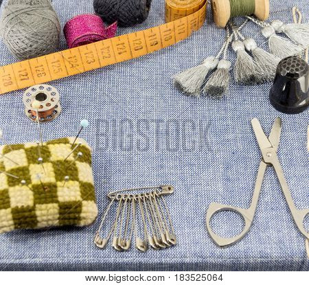 Beautifully Laid Out Accessories For Needlework On A Jeans Background