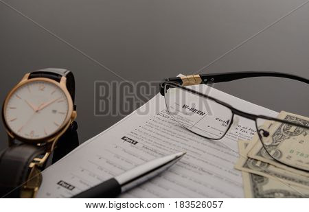 Concept the tax form W-8BEN and over things on the table
