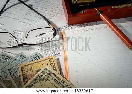 Concept the tax form W-8BEN and over things on the table