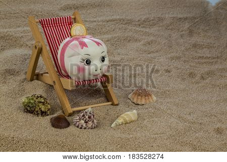 deckchair with piggy bank and euro