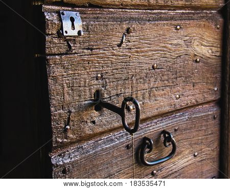 The old key in brown wooden door