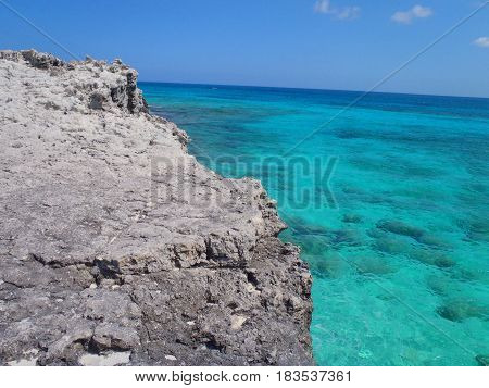 Crystal clear coral filled ocean seen from a cliff
