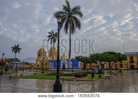 Trujillo, Peru - January 11, 2014: Bright yellow colonial style Cathedral in the Plaza de Armas of Trujillo in early morning Peru