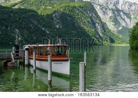 Koenigssee, Germany - August 16, 2010: Tourist boat on pier. Mountain lake Koenigssee Bavaria