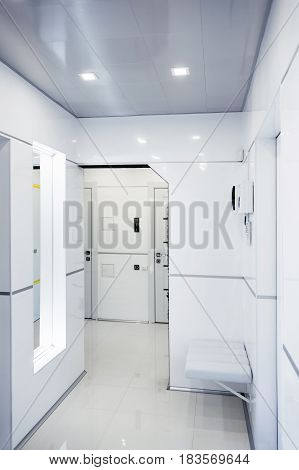 Modern home hallway interior. White plactic panels and tiles. Futuristic interior concept design. Space ship at home