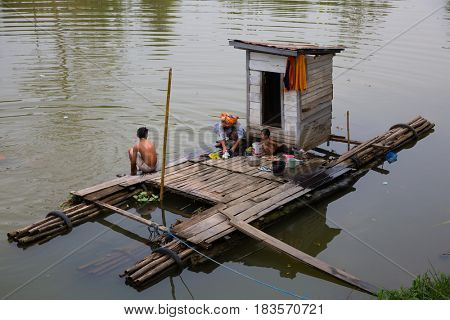 Kalimantan, Indonesia - september 20, 2015: Kalimantan family bathing and washing on their floating bathroom in Kalimantan, Indonesia