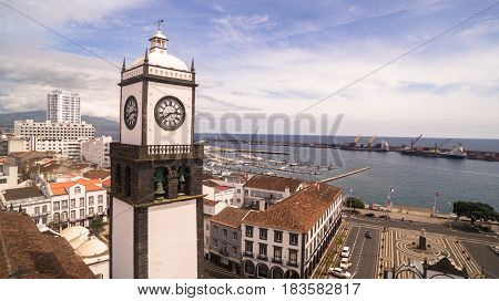 Saint Sabastian church with clock tower in Ponta Delgada on Sao Miguel Island in Azores, Portugal. Beautiful church in early morning under white clouds.
