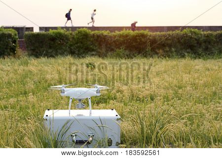 KAGAWA, JAPAN - APRIL 23, 2017: White drone Dji Phantom4Pro stay on metal bag and ready to fly.