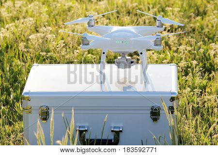 KAGAWA, JAPAN - APRIL 23, 2017: White drone Dji Phantom4Pro stay on metal bag and ready to fly.