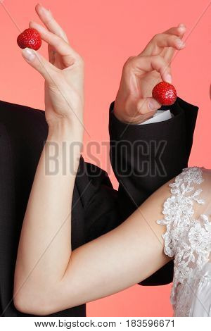 Hand And Strawbery On Red