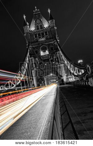 Tower Bridge in London in black and white, UK at night with blur colored car lights. One of the most famous history building in England