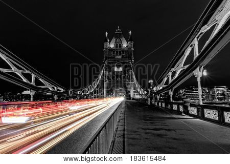 Tower Bridge in London in black and white, UK at night with blur colored car lights. One of the most famous history building in England