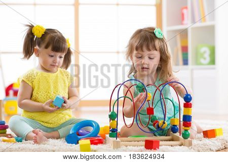 Children playing with toys in kindergarten or home