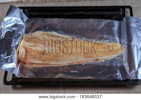 Fillet Is Fresher Than Fish In Seasoning On A Foil On A Black Background