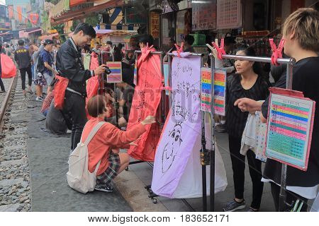TAIPEI TAIWAN - DECEMBER 5, 2016: Unidentified people fly sky lantern in Shifen town. Shifen is an old railroad town and popular tourist destination.