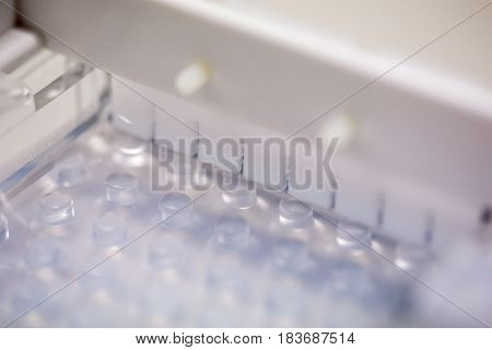 Close-up macro detail of a plastic well comb in a setting agarose electrophoresis gel mold. Healthcare and molecular genetics concept.