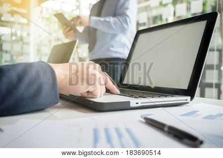 Team work process. young business managers crew working with new startup financial project. labtop on wood table typing keyboard texting message analyze graph plans.