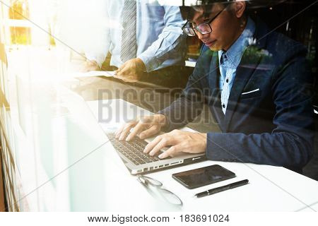 Team work process. young business managers crew working with new startup financial project. labtop on wood table typing keyboard texting message analyze graph plans.
