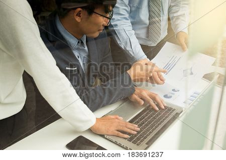 Teamwork process Business People Discussion Marketing Plan Meeting Concept on table with laptop and financial document data in office.