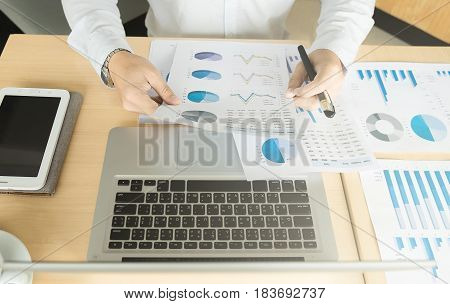 Business man working at office with laptoptablet and documents on his desk.