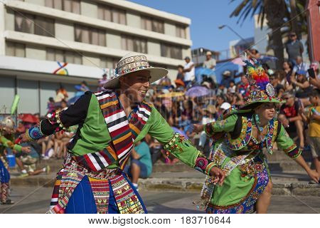 ARICA, CHILE - FEBRUARY 11, 2017: Tinkus dancers dressed in ornate costumes performing during a street parade at the annual Carnaval Andino con la Fuerza del Sol in Arica, northern Chile.